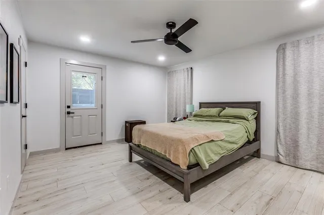 a bathroom with a granite countertop sink toilet and mirror