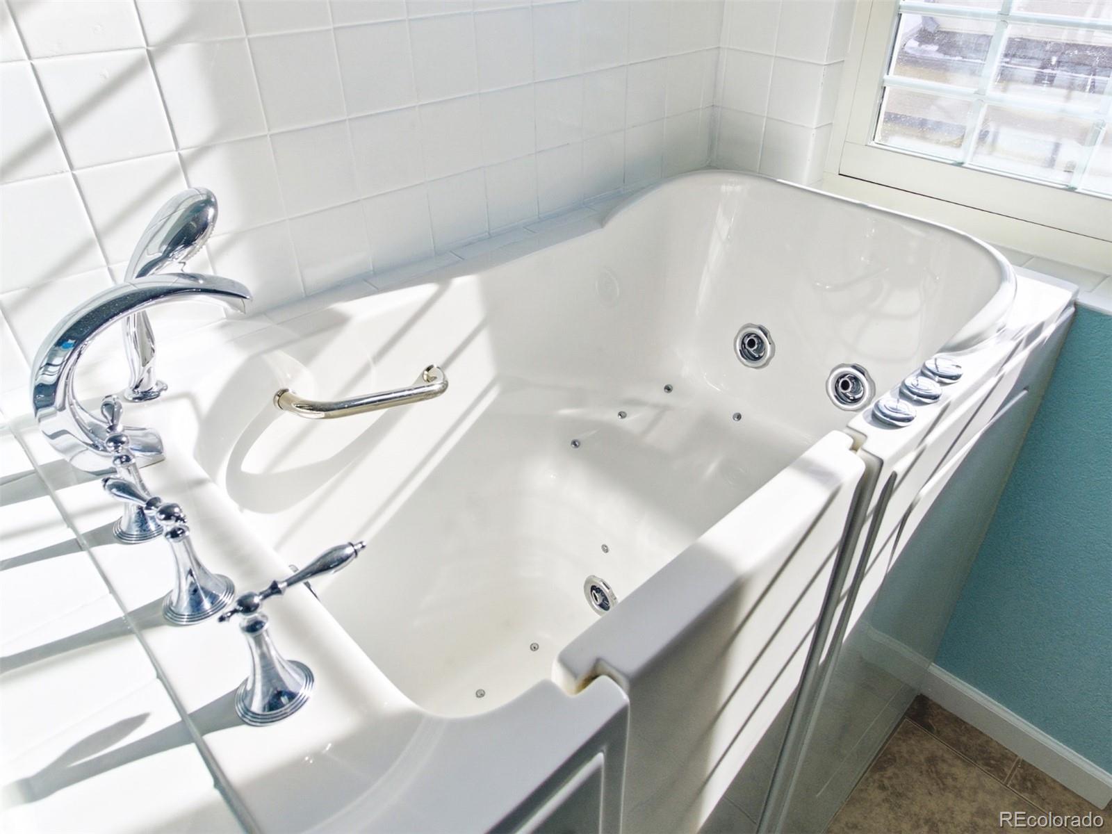 4301 South Pierce Street, Unit 2D Denver, CO 80123 - Photo 20 of 39 a bathroom with a tub and a shower