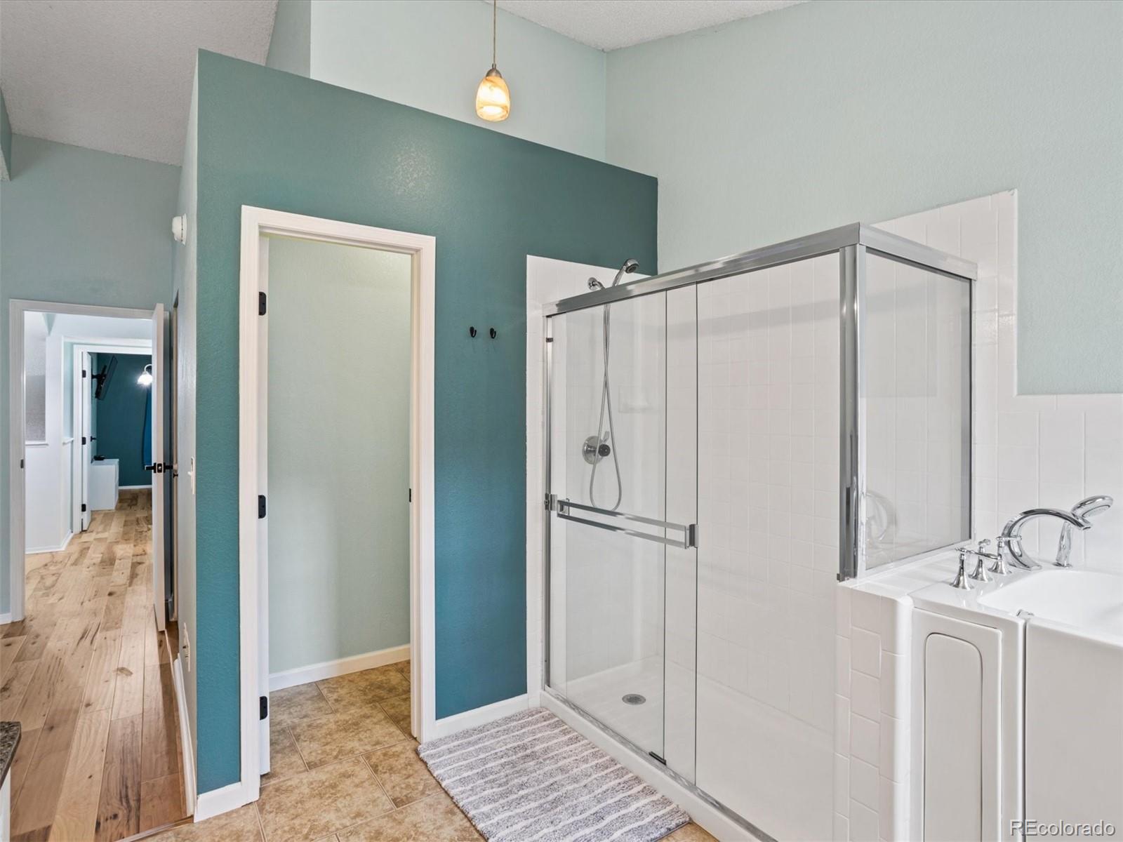 4301 South Pierce Street, Unit 2D Denver, CO 80123 - Photo 21 of 39 a bathroom with a shower and a sink