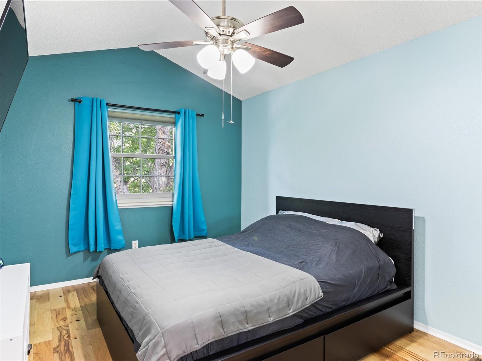 4301 South Pierce Street, Unit 2D Denver, CO 80123 - Photo 26 of 39 a bedroom with a bed and a window