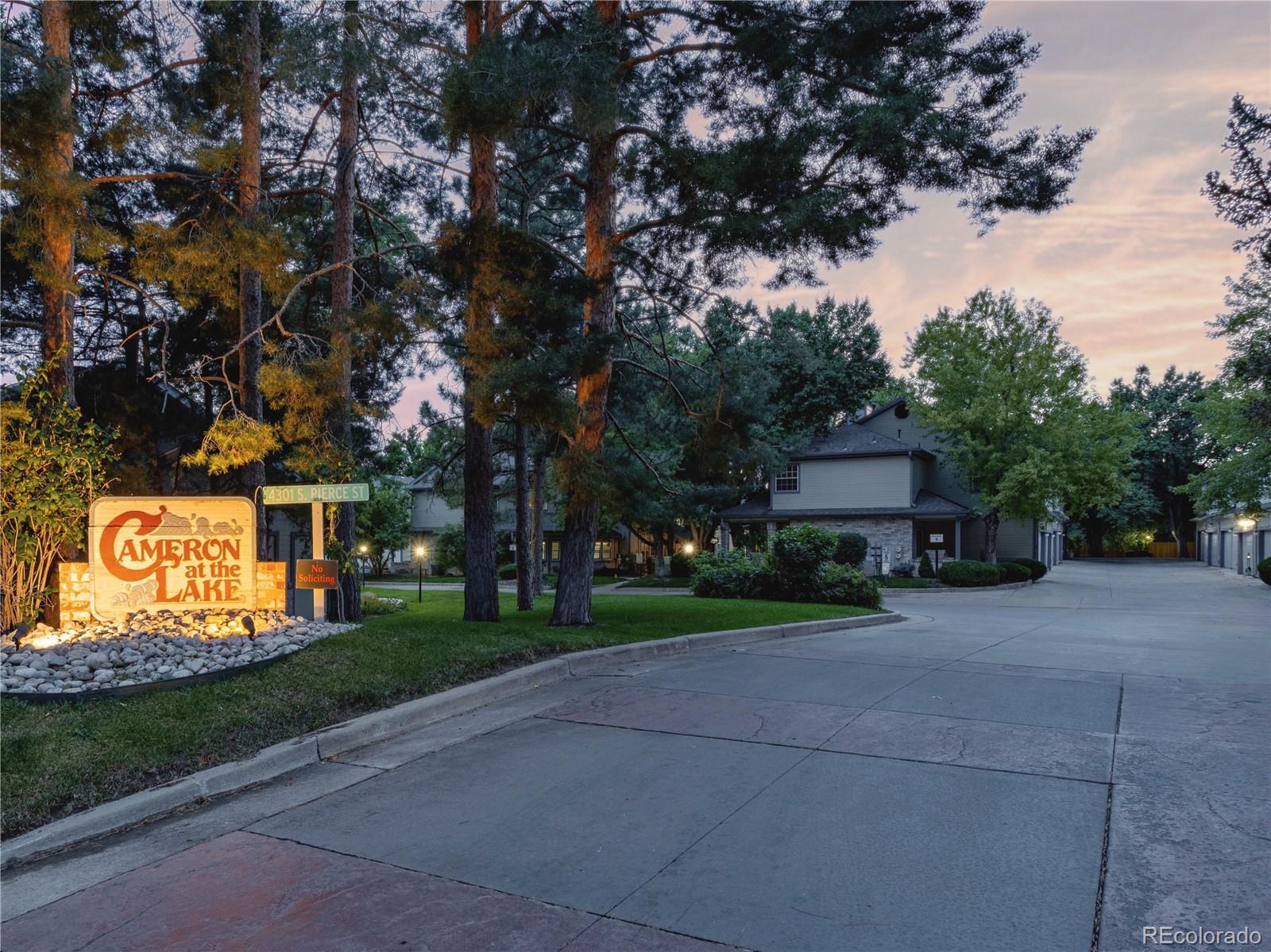4301 South Pierce Street, Unit 2D Denver, CO 80123 - Photo 33 of 39 a front view of a house with garden