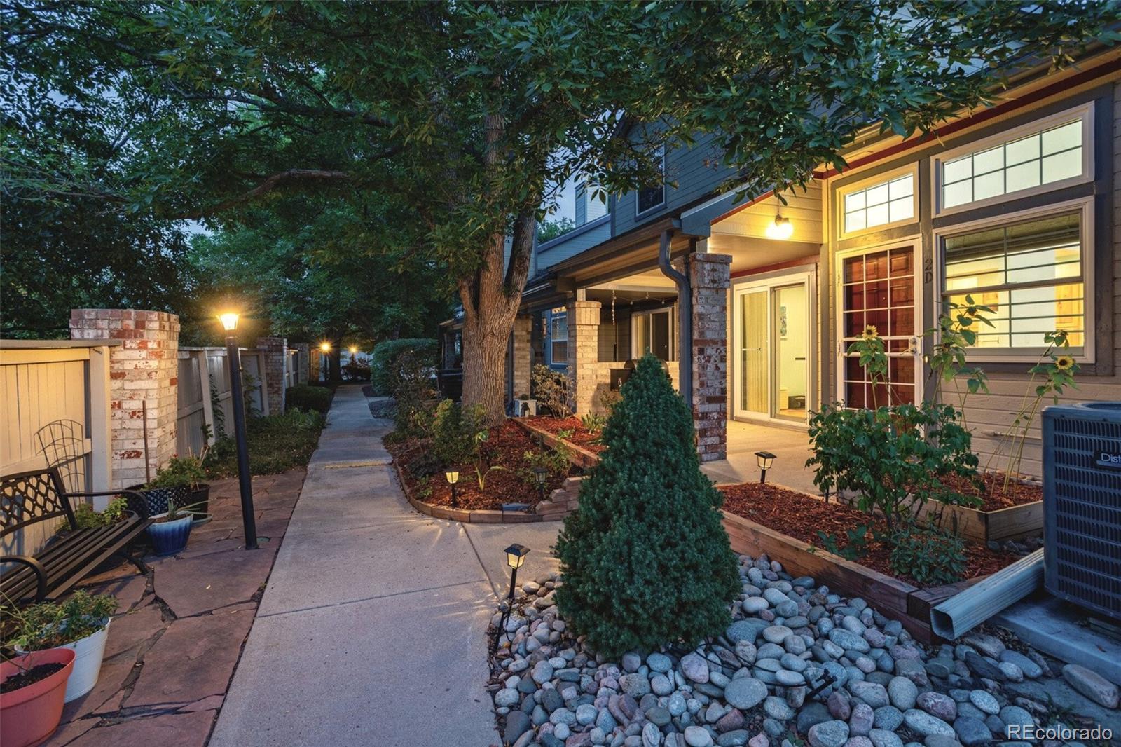 4301 South Pierce Street, Unit 2D Denver, CO 80123 - Photo 35 of 39 a front view of a house with a garden