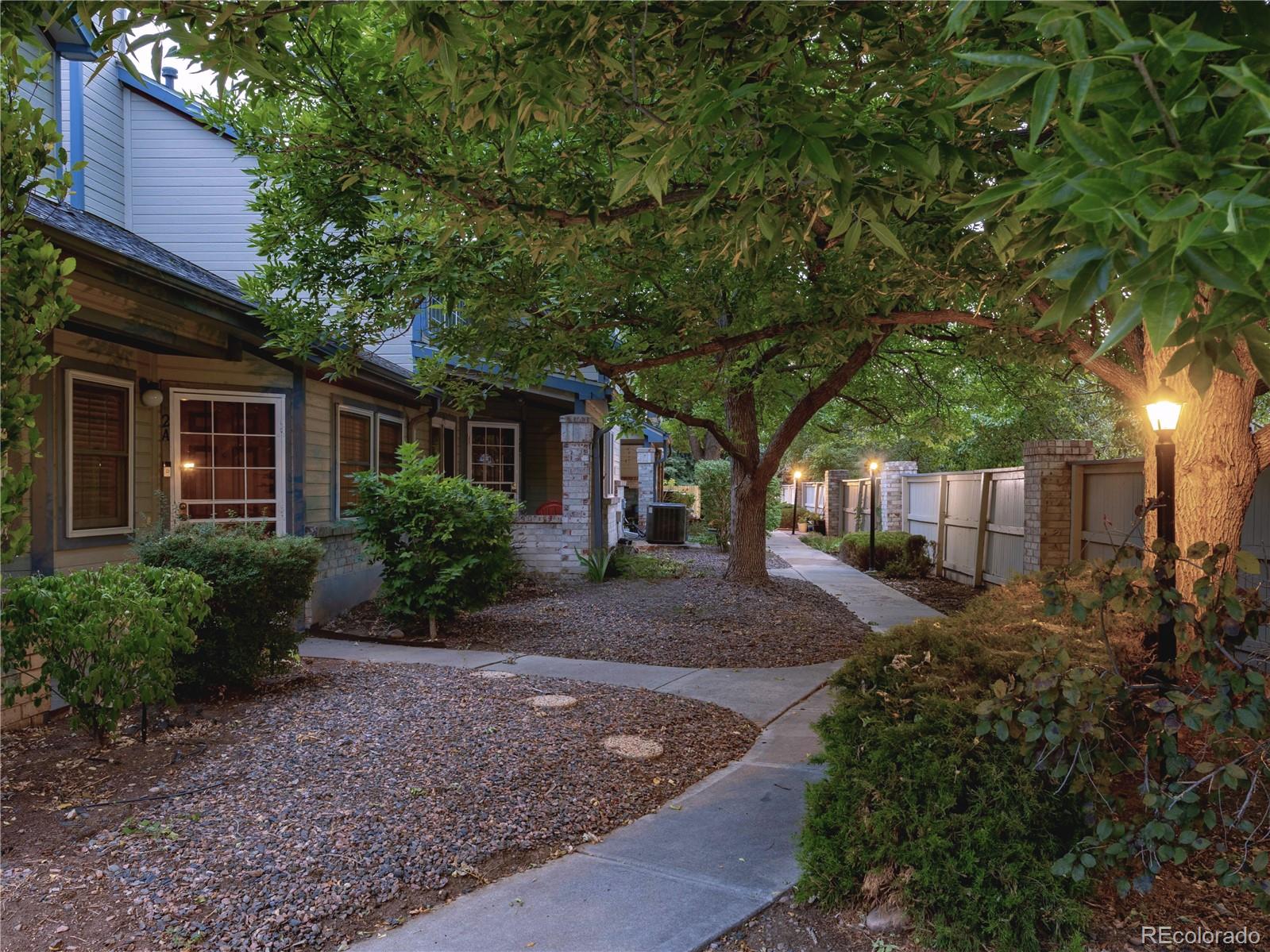 4301 South Pierce Street, Unit 2D Denver, CO 80123 - Photo 37 of 39 a front view of a house with garden