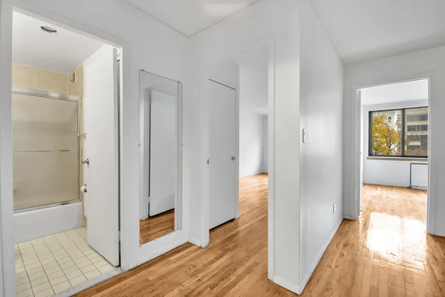 a kitchen with a sink a refrigerator and cabinets