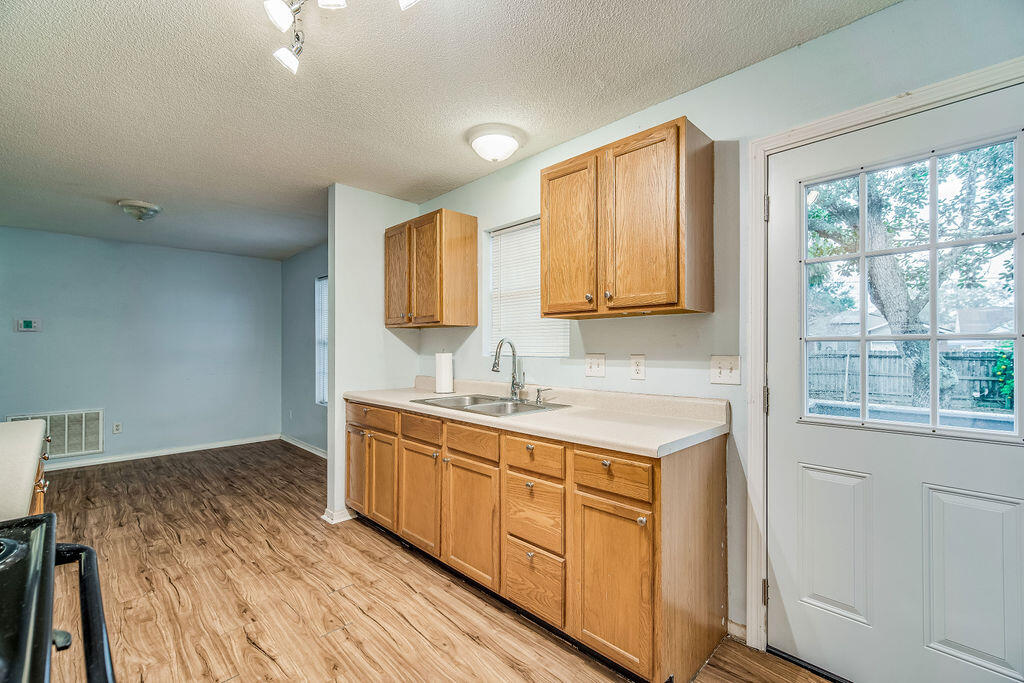 1003 Pinetree Road Mary Esther, FL 32569 - Photo 11 of 29 a kitchen with a sink stove and cabinets