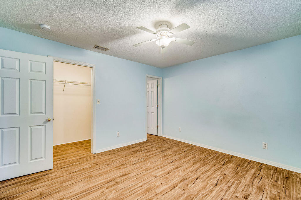 1003 Pinetree Road Mary Esther, FL 32569 - Photo 15 of 29 an empty room with wooden floor and windows