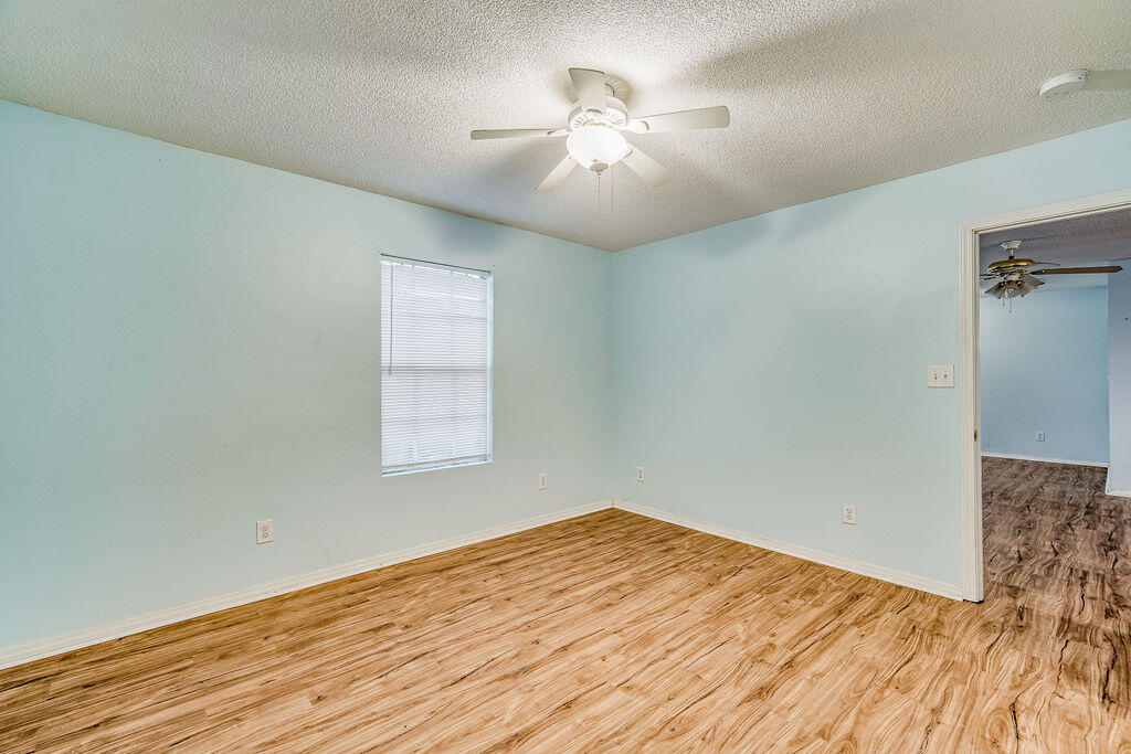 1003 Pinetree Road Mary Esther, FL 32569 - Photo 17 of 29 wooden floor in an empty room with a window