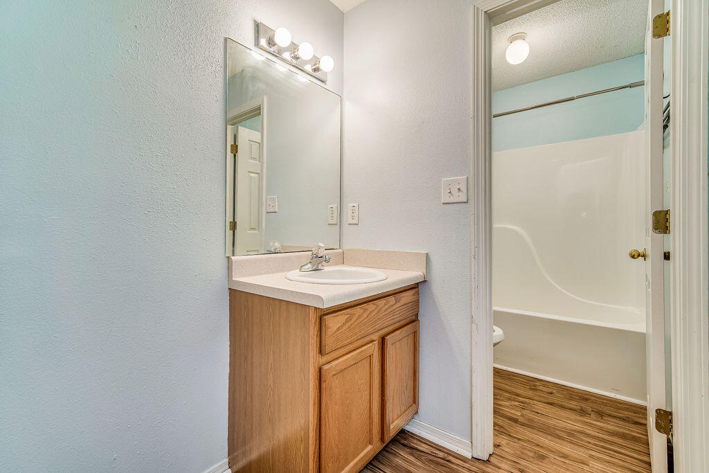 1003 Pinetree Road Mary Esther, FL 32569 - Photo 18 of 29 a bathroom with a sink a mirror and a shower