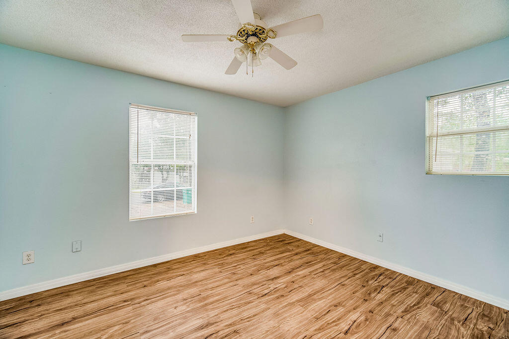 1003 Pinetree Road Mary Esther, FL 32569 - Photo 20 of 29 wooden floor in an empty room with a window