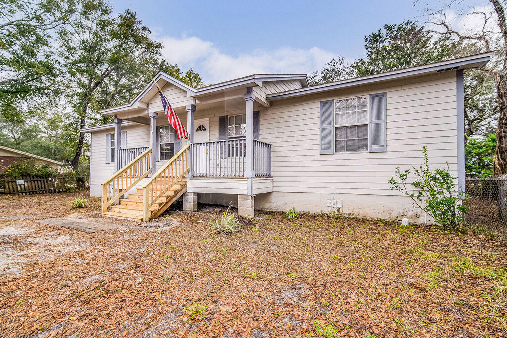 1003 Pinetree Road Mary Esther, FL 32569 - Photo 2 of 29 a view of a house with a yard