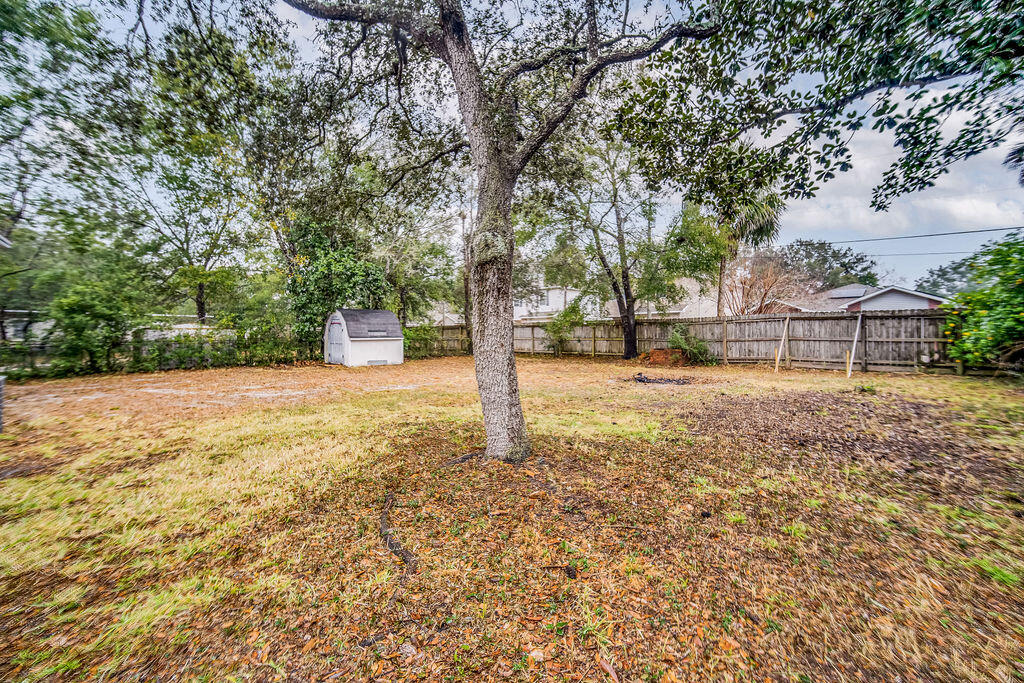 1003 Pinetree Road Mary Esther, FL 32569 - Photo 26 of 29 a backyard of a house with lots of green space