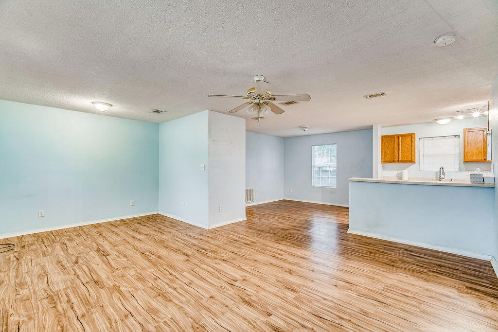 1003 Pinetree Road Mary Esther, FL 32569 - Photo 7 of 29 a view of empty room with wooden floor and fan