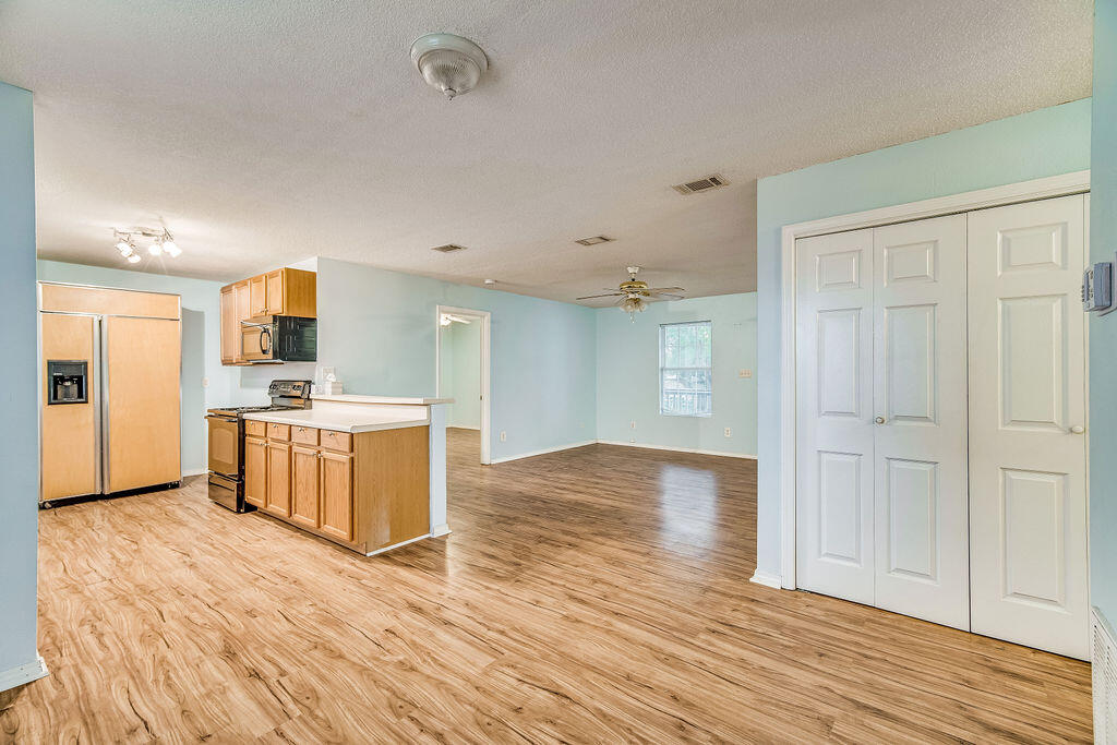 1003 Pinetree Road Mary Esther, FL 32569 - Photo 9 of 29 a view of kitchen and wooden floor