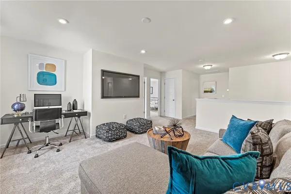 a bedroom with furniture a bed and a flat screen tv