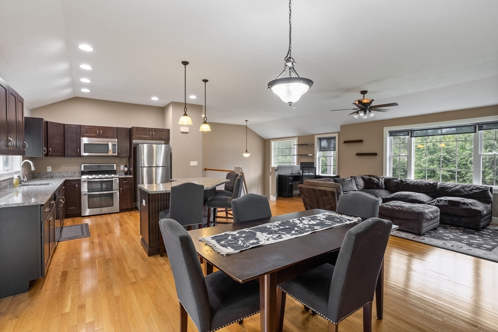 a living room with stainless steel appliances kitchen island granite countertop furniture and a kitchen view