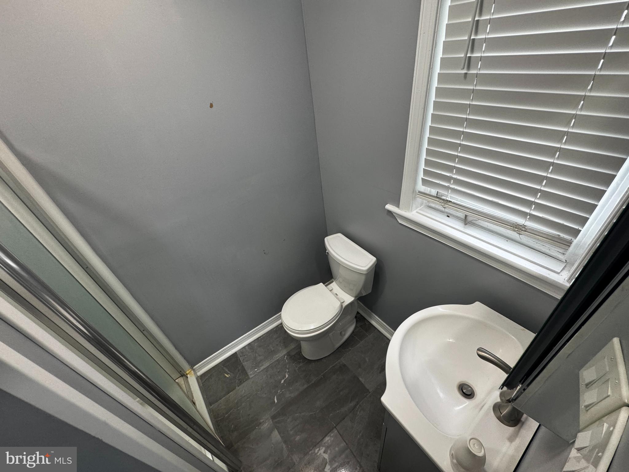700 Lloyd Street Chester, PA 19013 - Photo 24 of 32 a white toilet sitting next to a bathroom sink