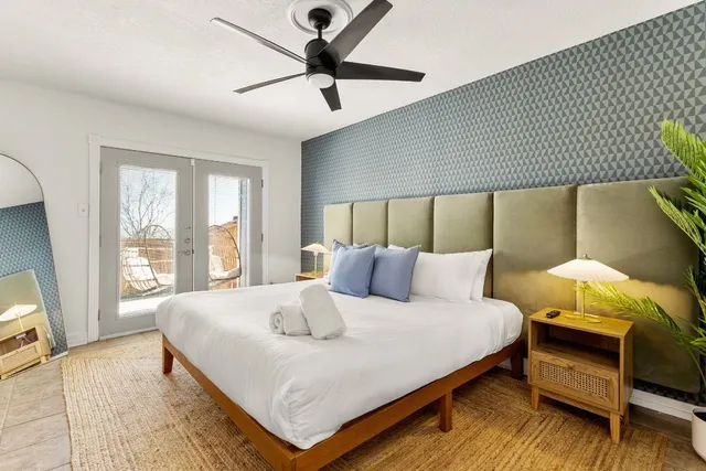 a bedroom with a bed and a chandelier