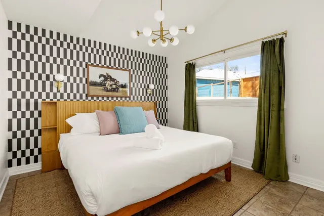 a bedroom with a bed and a window