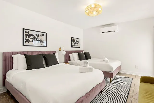 a large white bed in a white room