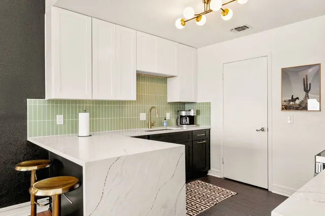 a kitchen with a sink cabinets and appliances
