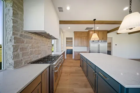 a kitchen with stainless steel appliances a sink and a stove