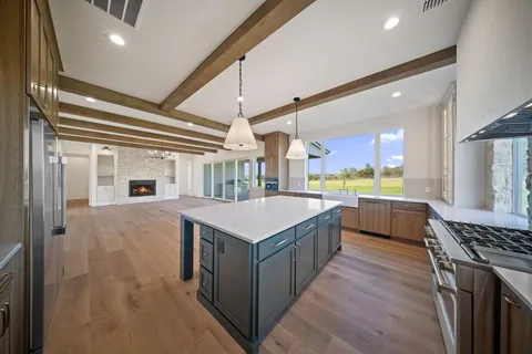 a kitchen with a stove and a refrigerator