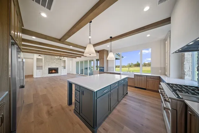 a kitchen with a stove and a refrigerator