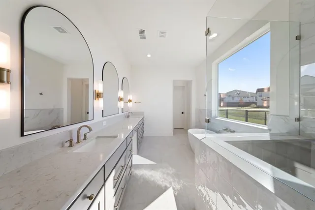 a bathroom with a granite countertop sink a mirror and a bathtub