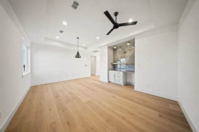 a view of a kitchen with a sink and wooden floor