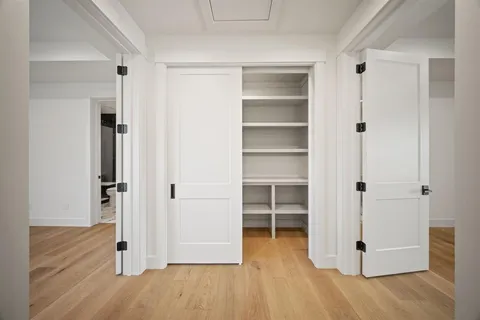 an empty room with wooden floor and closet