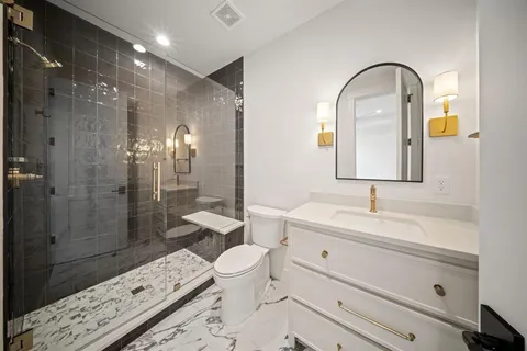 a spacious bathroom with a toilet sink and shower
