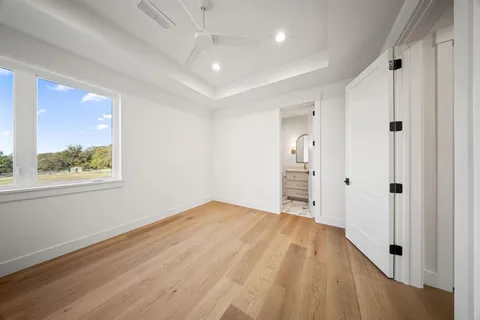 a view of a room with wooden floor and window