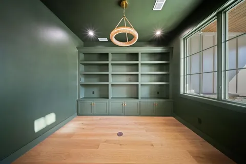 a room with a hardwood and a window