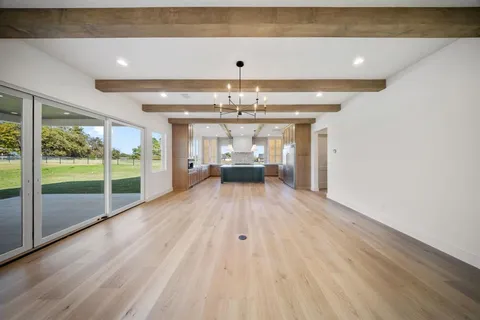 a view of an empty room with a fireplace and a window