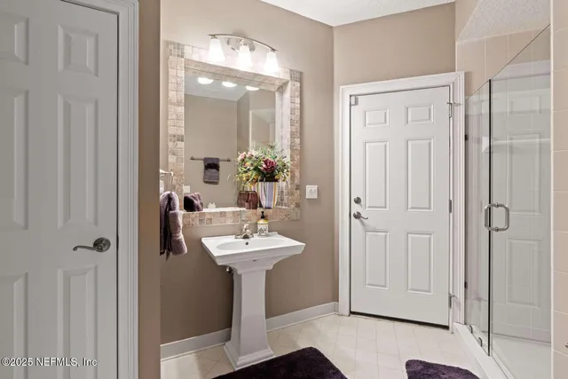 a bathroom with a sink a mirror and shower