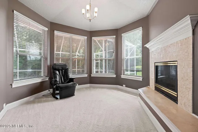 a bedroom with a bed a fireplace and a large window