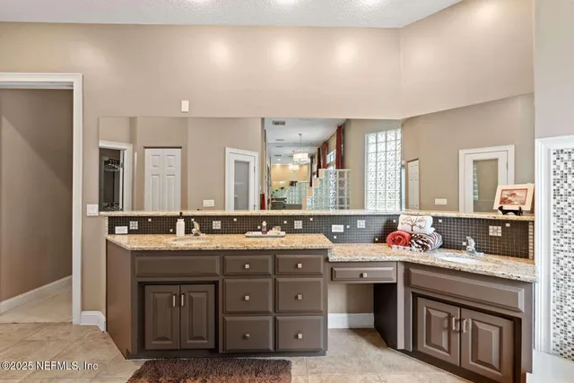 a bathroom with a tub a window and a fireplace