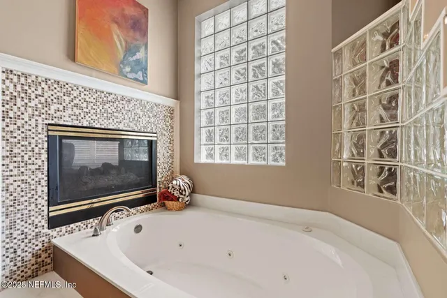 a bathroom with a shower and a glass door