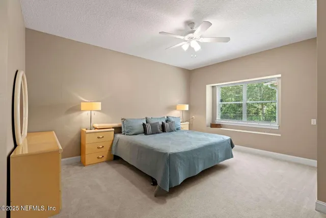 a bathroom with a sink a toilet a mirror and shower