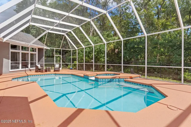 a view of a house with a big yard and large trees