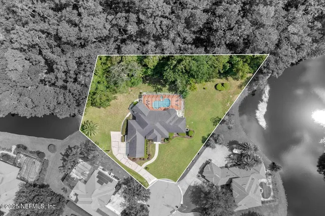 an aerial view of a house with a yard
