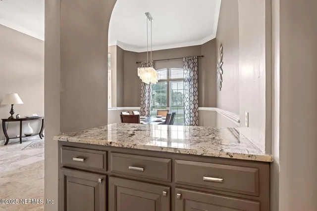 a kitchen with granite countertop a sink and cabinets
