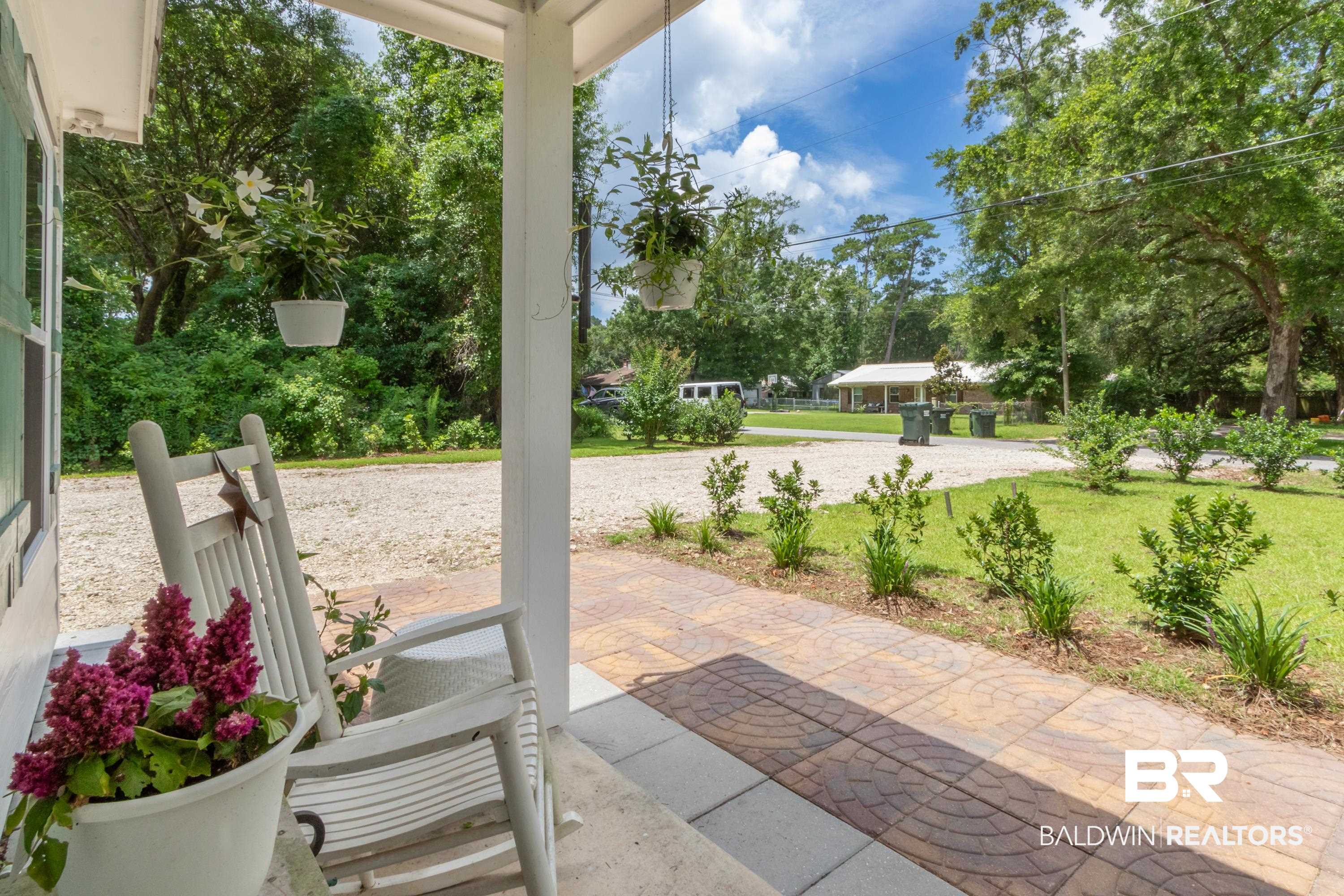 7472 Coopers Landing Road Foley, AL 36535 - Photo 25 of 40 Inviting covered porch featuring a tiled walkway and white support columns
