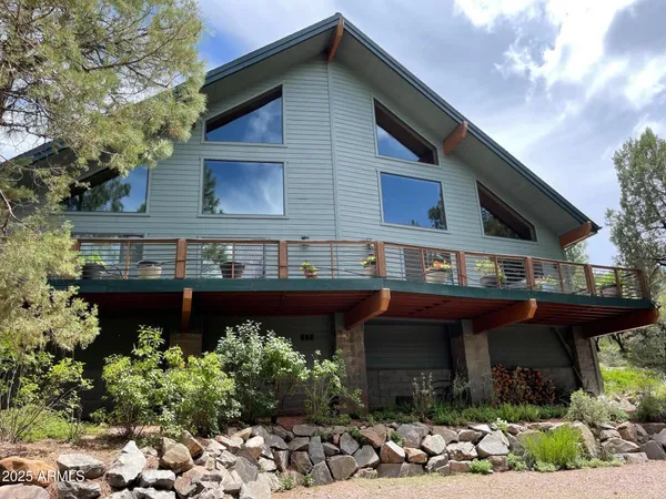 a front view of a house with plants and entryway