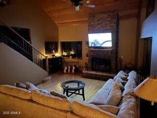 a living room with furniture a fireplace and a flat screen tv