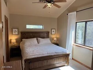 a bed sitting in a bedroom next to a window