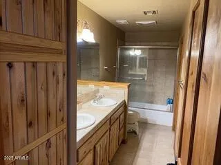 a view of a house with a yard and a large tree