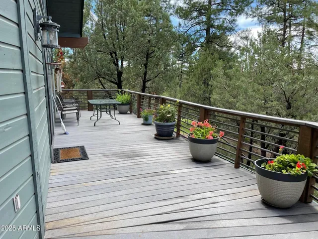 a view of roof deck with seating space and potted plants