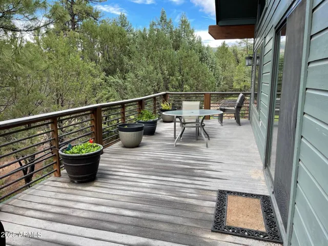 a view of a balcony with chair and potted plants