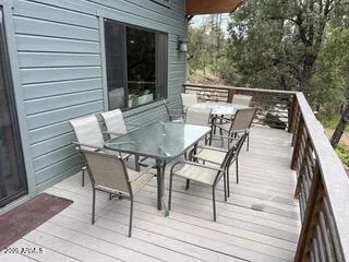 a view of backyard from deck having patio